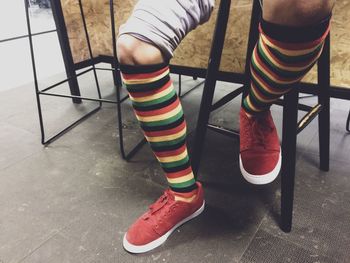 Low section of person standing on chair