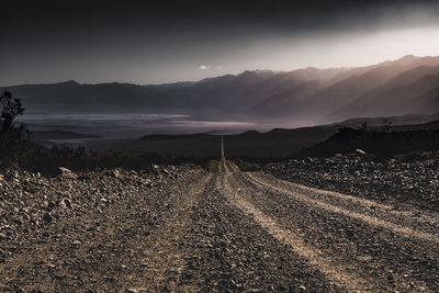 The road to the mountains during sunset at death valley national park