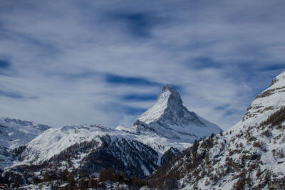 Scenic view of snowcapped mountains against sky