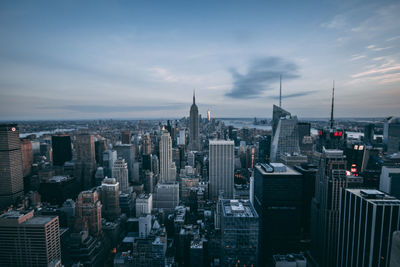 High angle view of buildings in city against cloudy sky