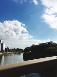 Scenic shot of calm river with city in background