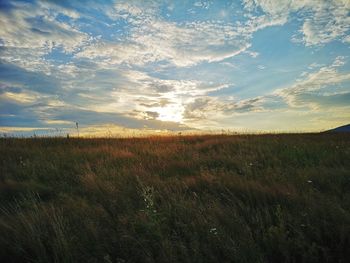 Scenic view of land against sky during sunset