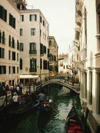 Boats in canal with buildings in background