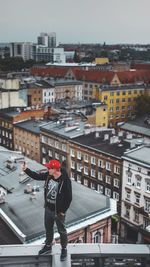 Full length of woman standing on city against sky