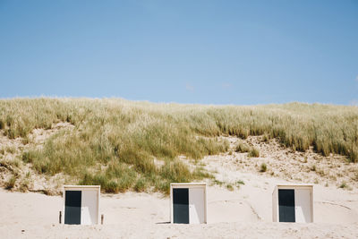 Tiny beach houses in the summer sun in schoorl, the netherlands, colorful travel photography 