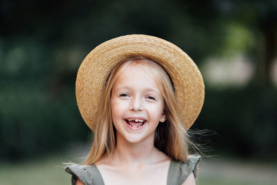 Portrait of young woman wearing hat