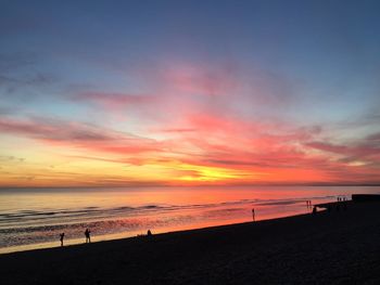 Scenic view of beach against sky during sunset