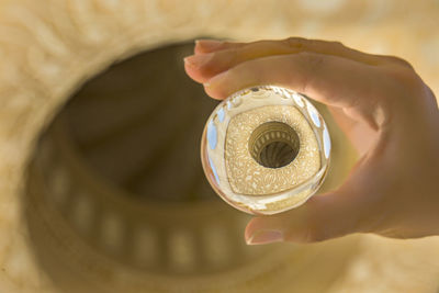 Close-up of hand holding coin