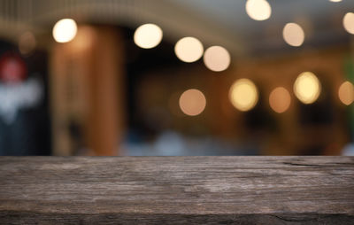 Defocused image of illuminated lights on table