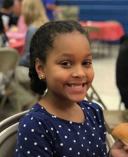 Portrait of smiling girl sitting at restaurant