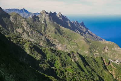 Panoramic view of sea and mountains against sky