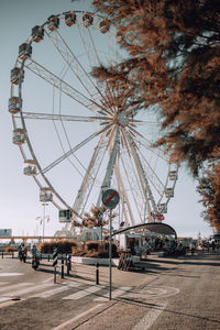 Ferris wheel against sky in city