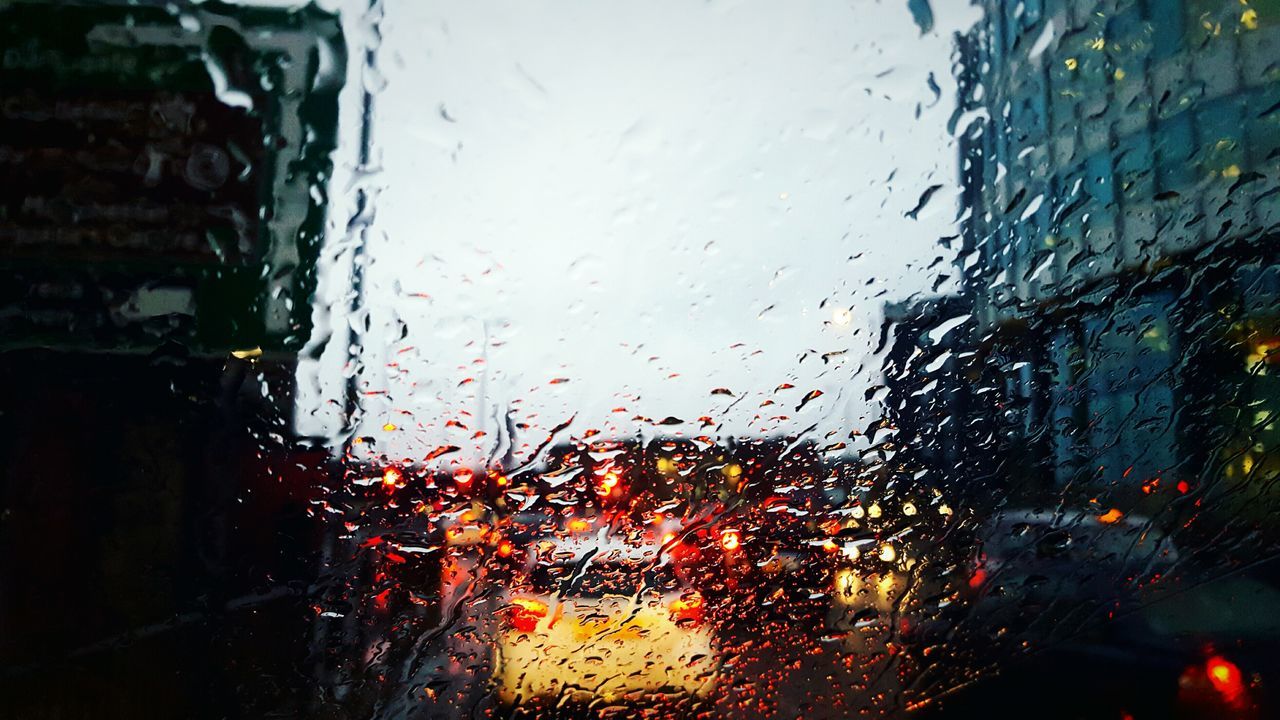 wet, rain, glass - material, water, drop, transparent, window, weather, car, rainy season, sky, mode of transport, transportation, vehicle interior, raindrop, dusk, close-up, land vehicle, monsoon, no people, backgrounds, day, droplet, nature, indoors