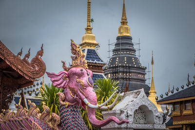 Statue of temple against building