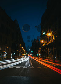 Light trails on road in city at night