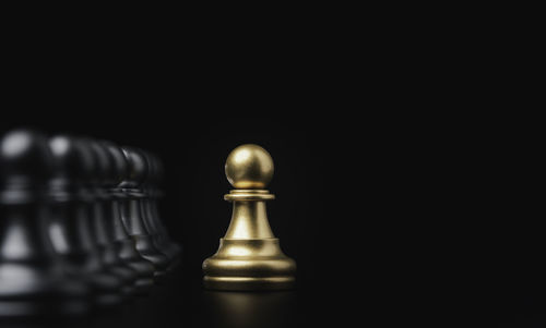 Close-up of chess pieces against black background