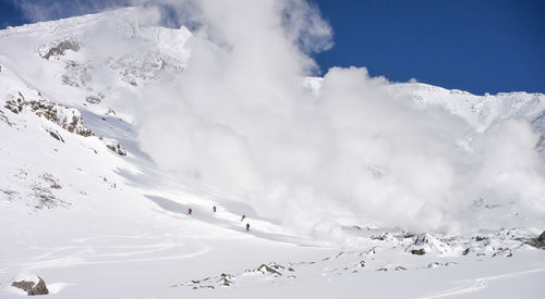 Aerial view of snowcapped mountains against sky