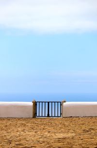 Lifeguard hut on beach against sky