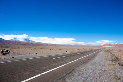 Scenic view of road against blue sky