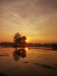 Scenic view of lake against orange sky