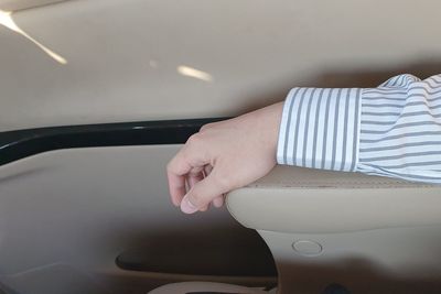 Cropped hand of man in car
