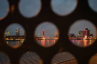 Illuminated buildings in city at waterfront