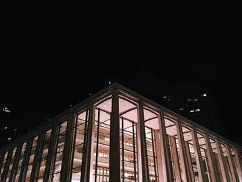 Low angle view of illuminated building against sky at night