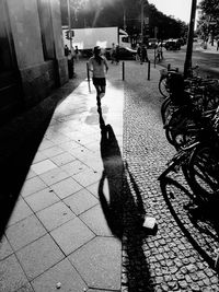 Woman walking on footpath