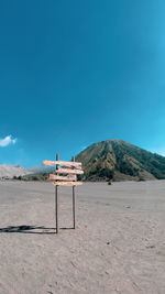 Scenic view of beach against blue sky