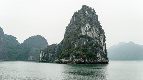 Rock formations in sea against sky