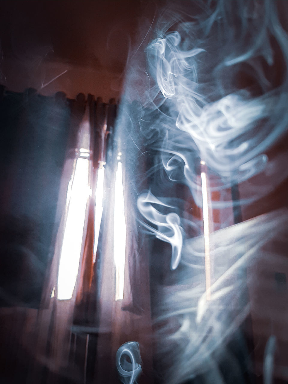 CLOSE-UP OF SMOKE EMITTING FROM LIGHT