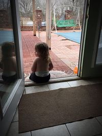 Full length of girl sitting on floor