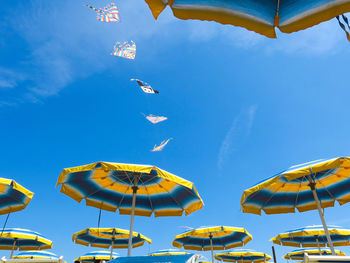 Low angle view of parasols against sky