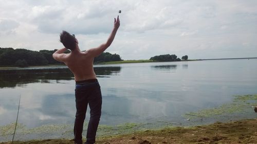 Rear view of woman standing in lake