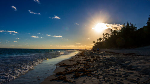 Scenic view of beach against sky during sunset