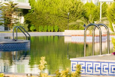 Swimming pool by lake in city