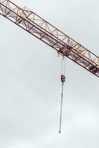 Low angle view of crane against sky