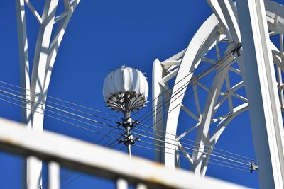 Low angle view of cables against clear blue sky