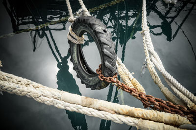 High angle view of tire tied up with rope