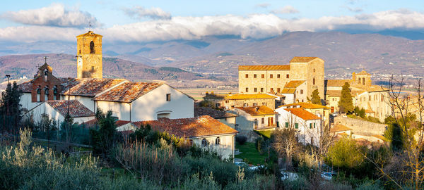 Buildings in town against sky