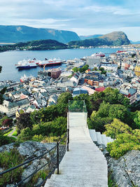 High angle view of townscape by sea against sky