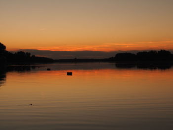 Scenic view of lake at sunset