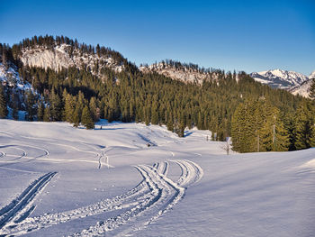 Scenic view of snow covered mountains against sky