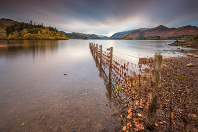 Calm lake against mountain range