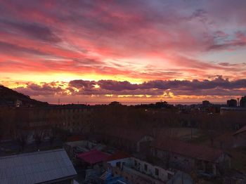 High angle shot of townscape against orange sky