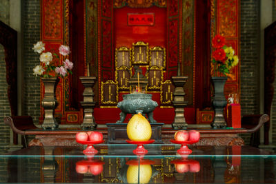 Chinese altar for worship ancestors with reflection on table