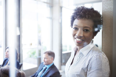 Portrait of businesswoman standing in conference room