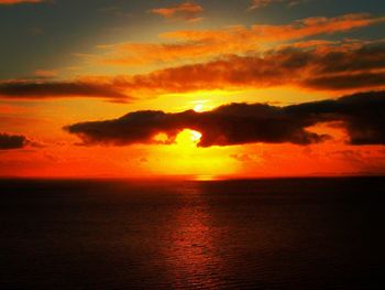 Scenic view of sea against romantic sky at sunset