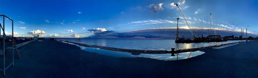 Panoramic view of bay against sky at dusk