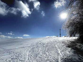 Snow covered land against sky